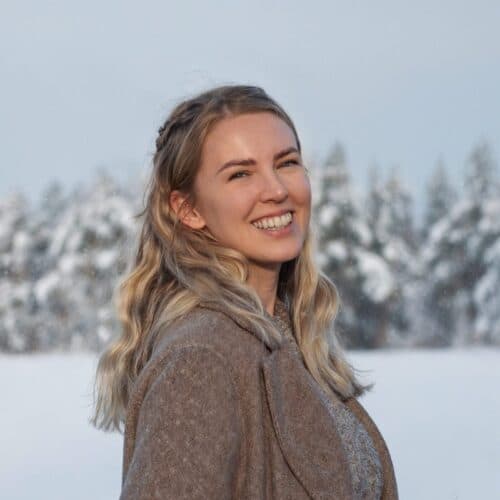 Michelle, smiling, in a snowy forest